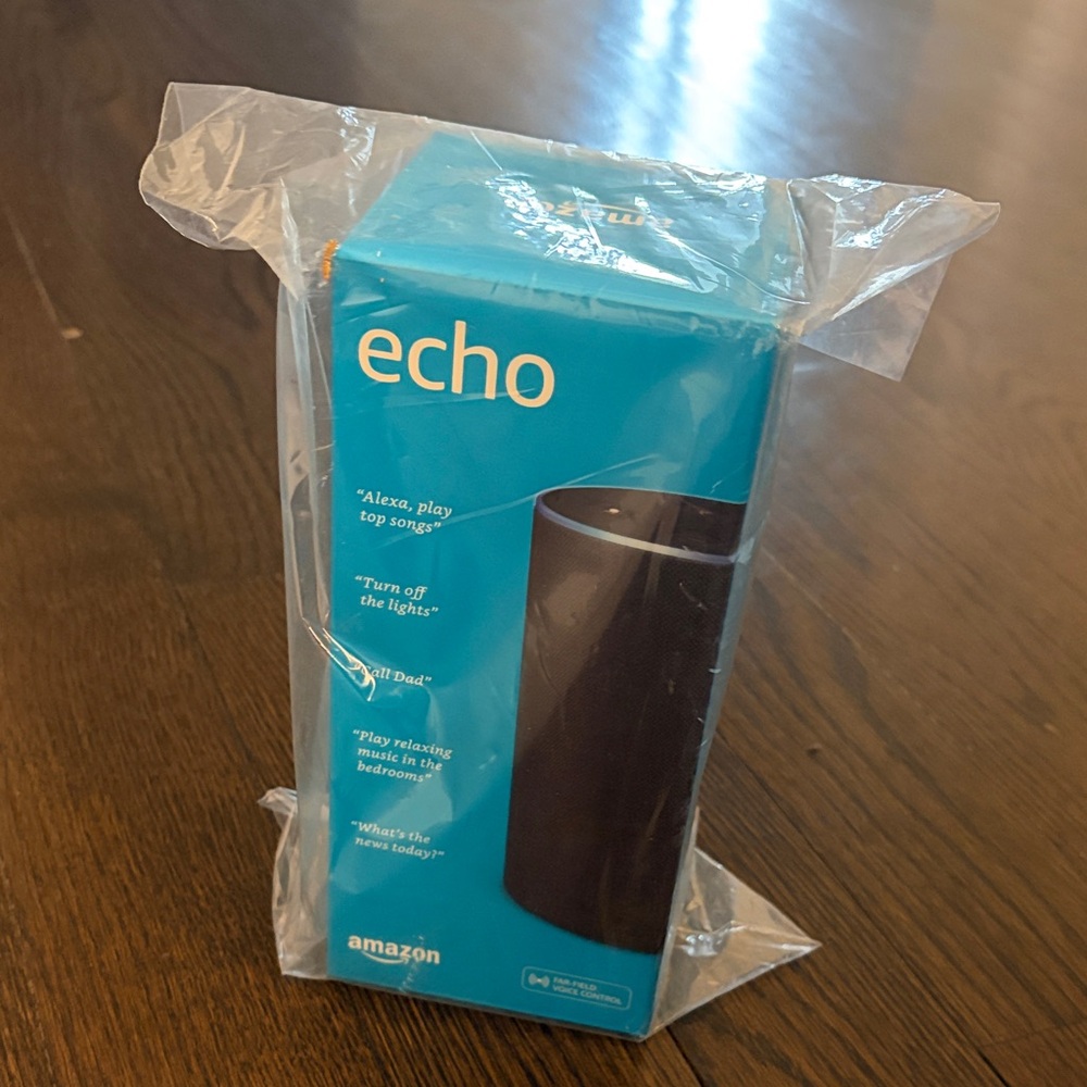 Amazon Echo Smart Speaker - Turquoise Packaging with Black Device Image.